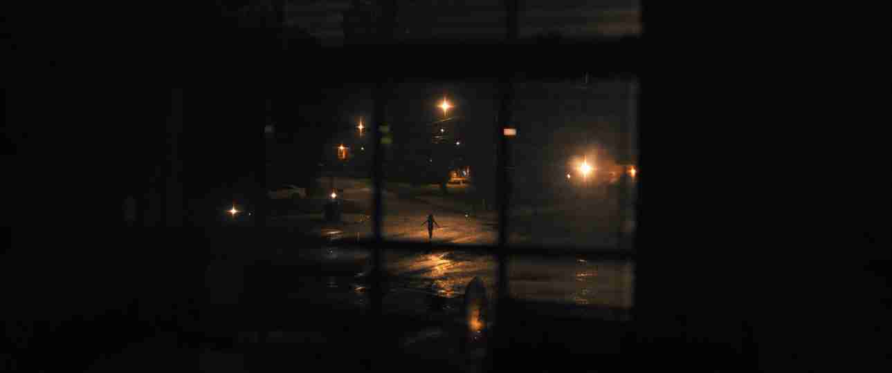 Weapons - A Figure on a Rain-Soaked Street