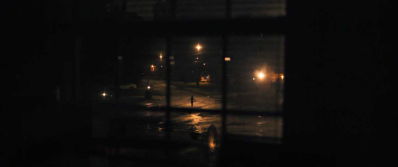 Weapons - A Figure on a Rain-Soaked Street