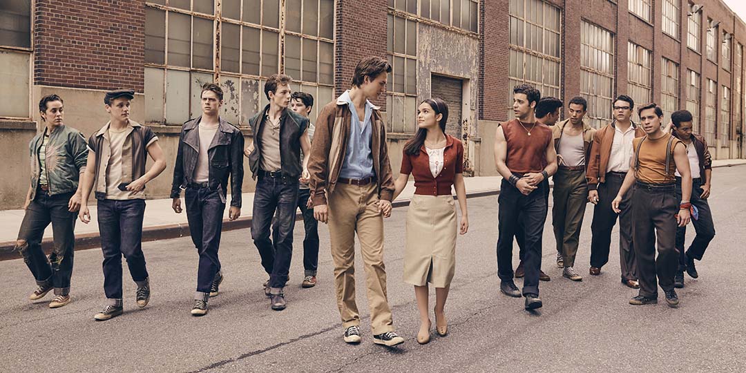 (L to R) Ezra Menas, Ben Cook, Sean Harrison Jones, Mike Faist, Patrick Higgins, Ansel Elgort, Rachel Zegler, David Alvarez, Julius Anthony Rubio, Ricardo Zayas, Josh Andrés Rivera, Sebastian Serra, and Carlos Sánchez Falú in 'West Side Story'