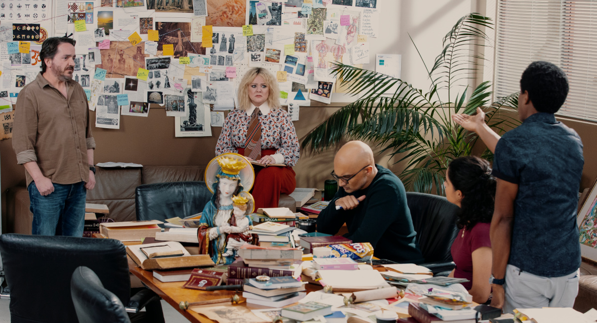 Ben Falcone as Clark Thompson, Melissa McCarthy as Amily Luck, Usman Ally as Mohsin Raza, Ana Scotney as Wendy, Chris Sandiford as Tom in 'God’s Favorite Idiot.'