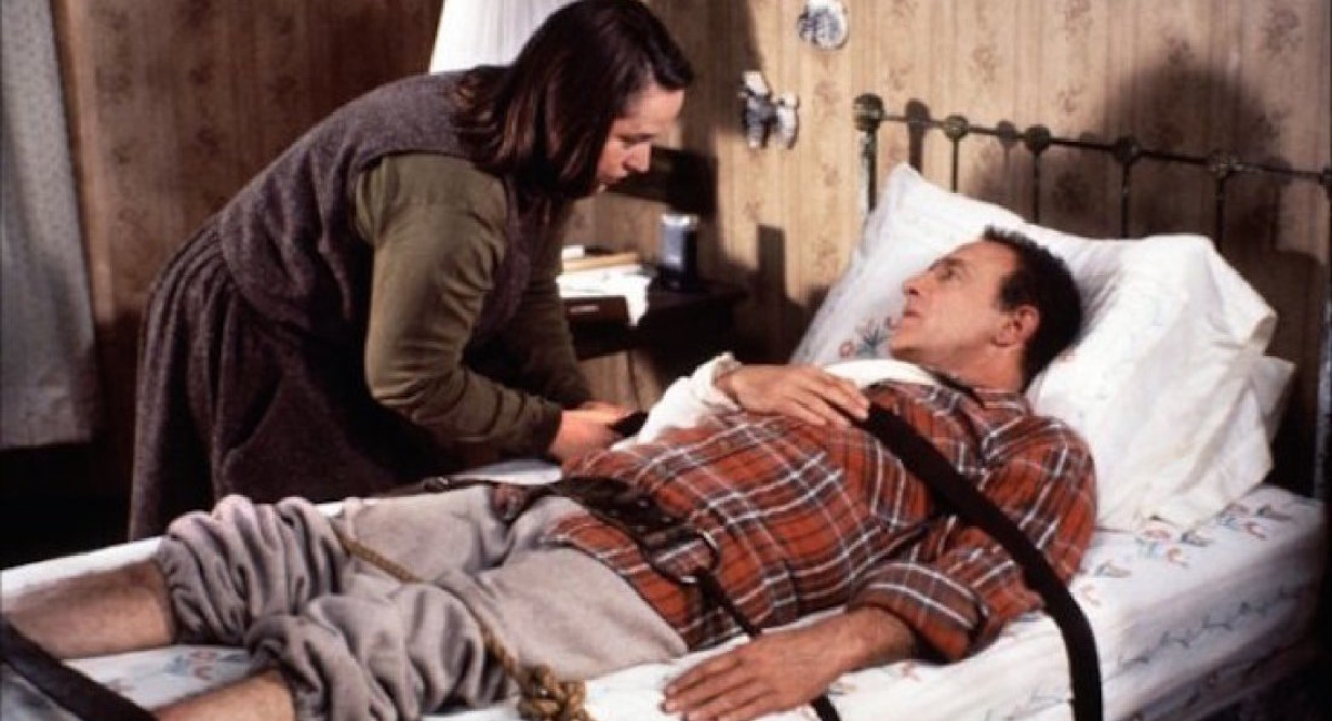 Kathy Bates as Annie Wilkes and James Caan as Paul Sheldon in director Rob Reiner's 'Misery' (1990).
