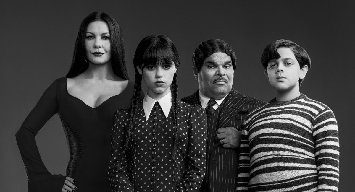Catherine Zeta-Jones as Morticia Addams, Jenna Ortega as Wednesday Addams, Luis Guzmán as Gomez Addams, and Isaac Ordonez as Pugsley Addams in Netflix's 'Wednesday.'