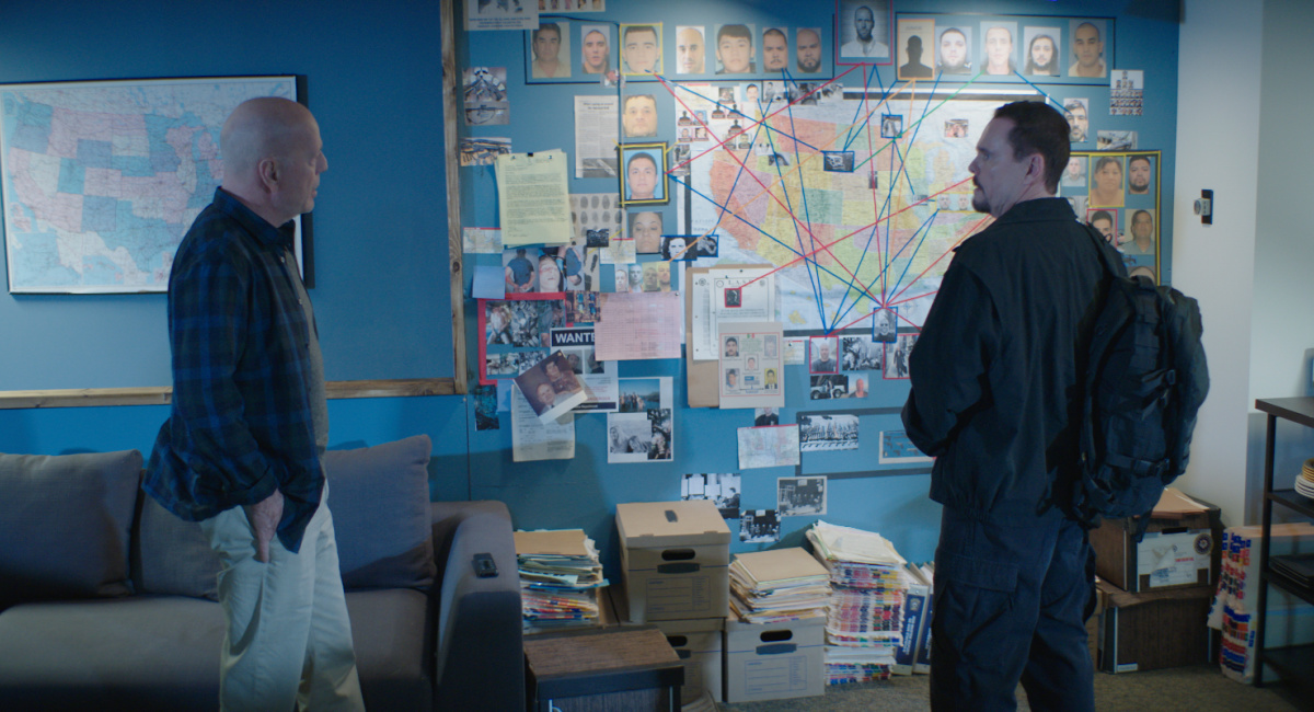 Bruce Willis as Shane Mueller and Kevin Dillon as Justin Rosa in the action film, 'Wire Room.'