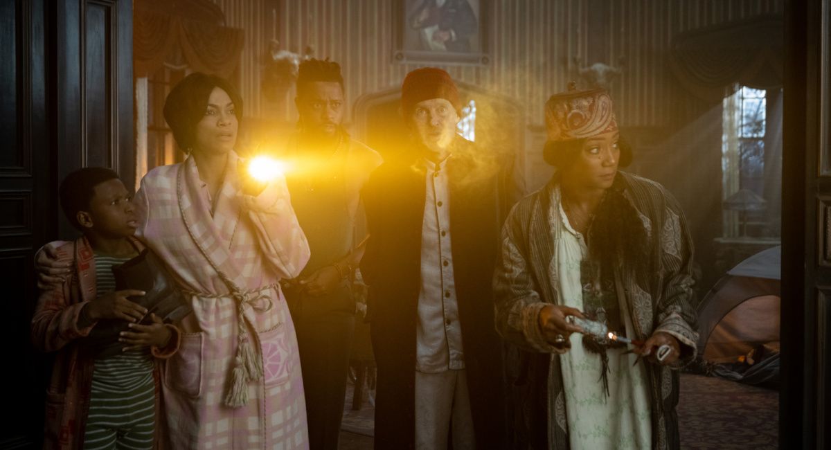 Chase Dillon as Travis, Rosario Dawson as Gabbie, LaKeith Stanfield as Ben, Owen Wilson as Father Kent, and Tiffany Haddish as Harriet in Disney's 'Haunted Mansion.'
