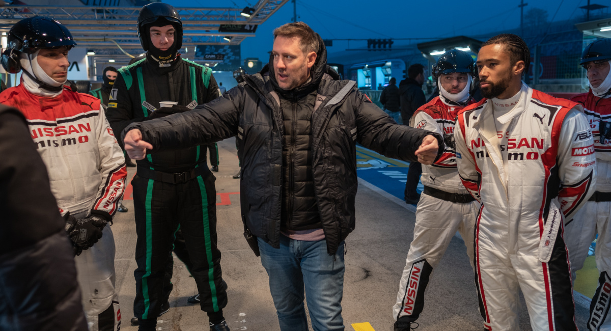 Director Neill Blomkamp (center) and the real Jann Mardenborough (right) with additional crew on the set of Columbia Pictures 'Gran Turismo.