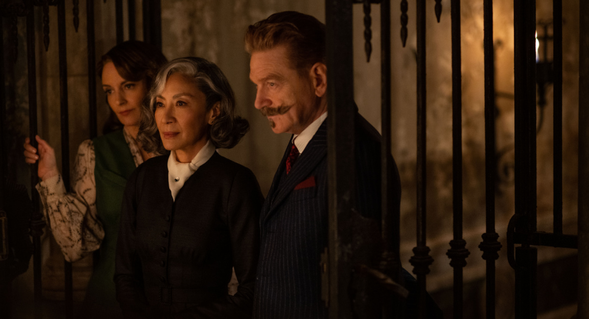 Tina Fey as Ariadne Oliver, Michelle Yeoh as Mrs. Reynolds, and Kenneth Branagh as Hercule Poirot in 20th Century Studios' 'A Haunting In Venice.'