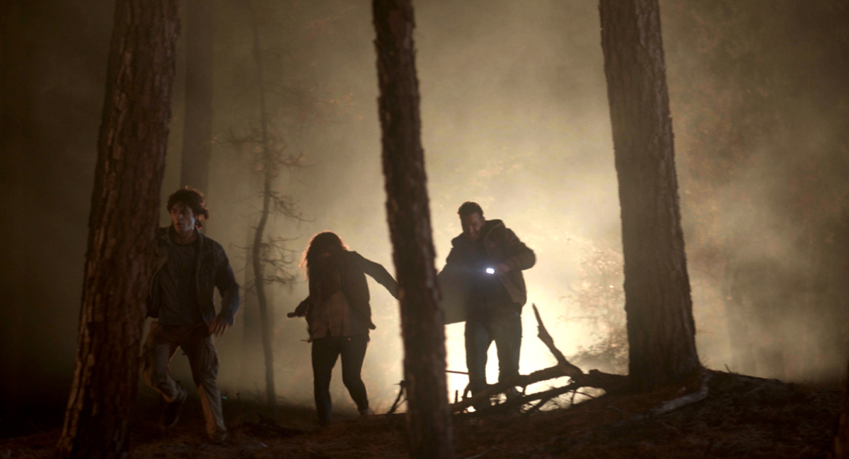Asher Angel as “Clayton Laughlin,” Fiona Dourif as “Sarah Laughlin,” and Peter Facinelli as “Dave Laughlin” in the survival drama/thriller, 'On Fire,' a Cineverse release.