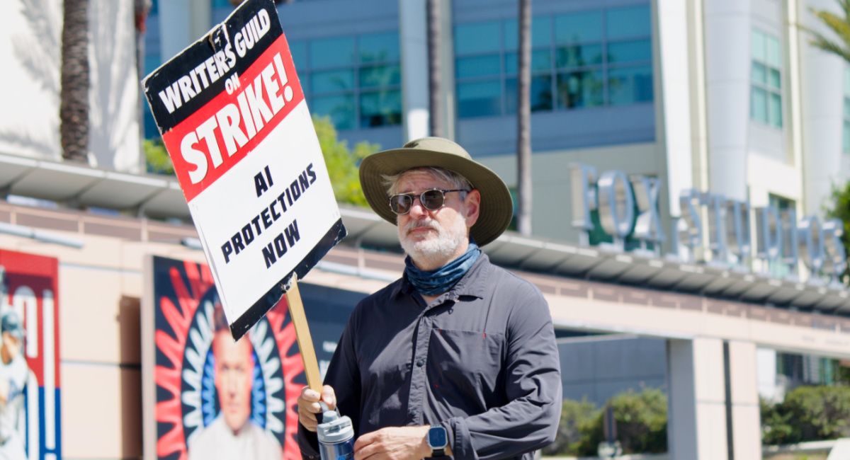 WGAW member urges "AI Protections Now" at 9/12's Showrunner Solidarity picket at Fox.