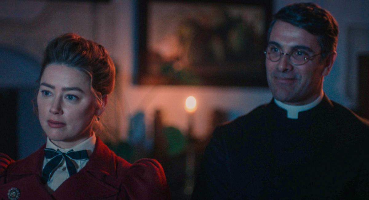 Amber Heard as Grace Burnham and Luca Calvani as Father Antonio in the thriller 'In the Fire,' a Saban Films release.