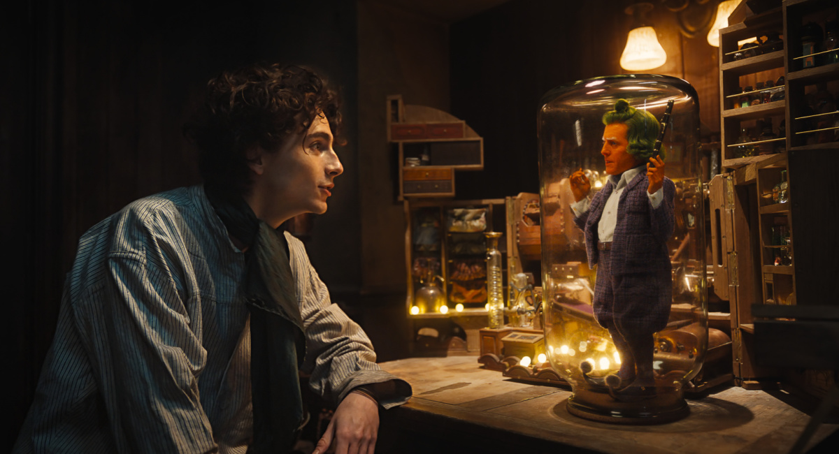 Timothée Chalamet as Willy Wonka and Hugh Grant as Oompa Loompa in the Warner Bros. Pictures and Village Roadshow Pictures 'Onka' Warner Bros. Pictures release.