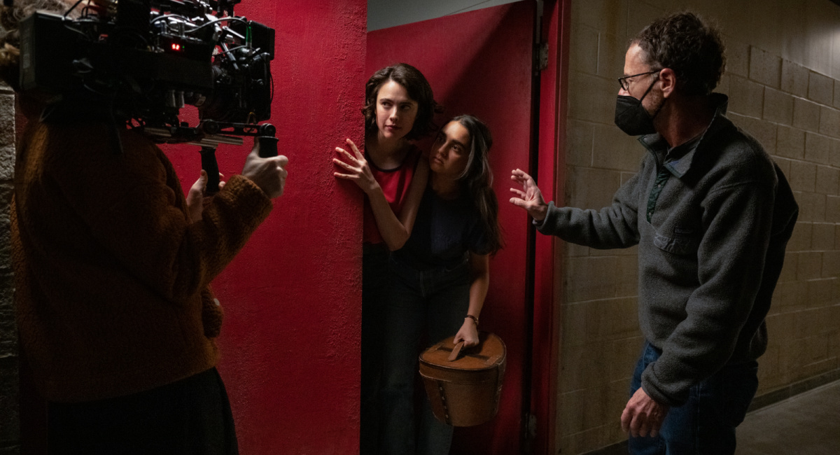Actor Margaret Qualley, actor Geraldine Viswanathan and director/writer/producer Ethan Coen on the set of 'Drive-Away Dolls,' a Focus Features release.