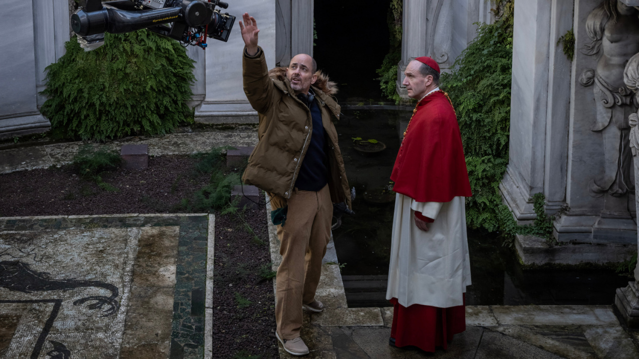 (L to R) Director Edward Berger and actor Ralph Fiennes on the set of 'Conclave', a Focus Features release. Credit: Philippe Antonello/Focus Features ©2024 All Rights Reserved.