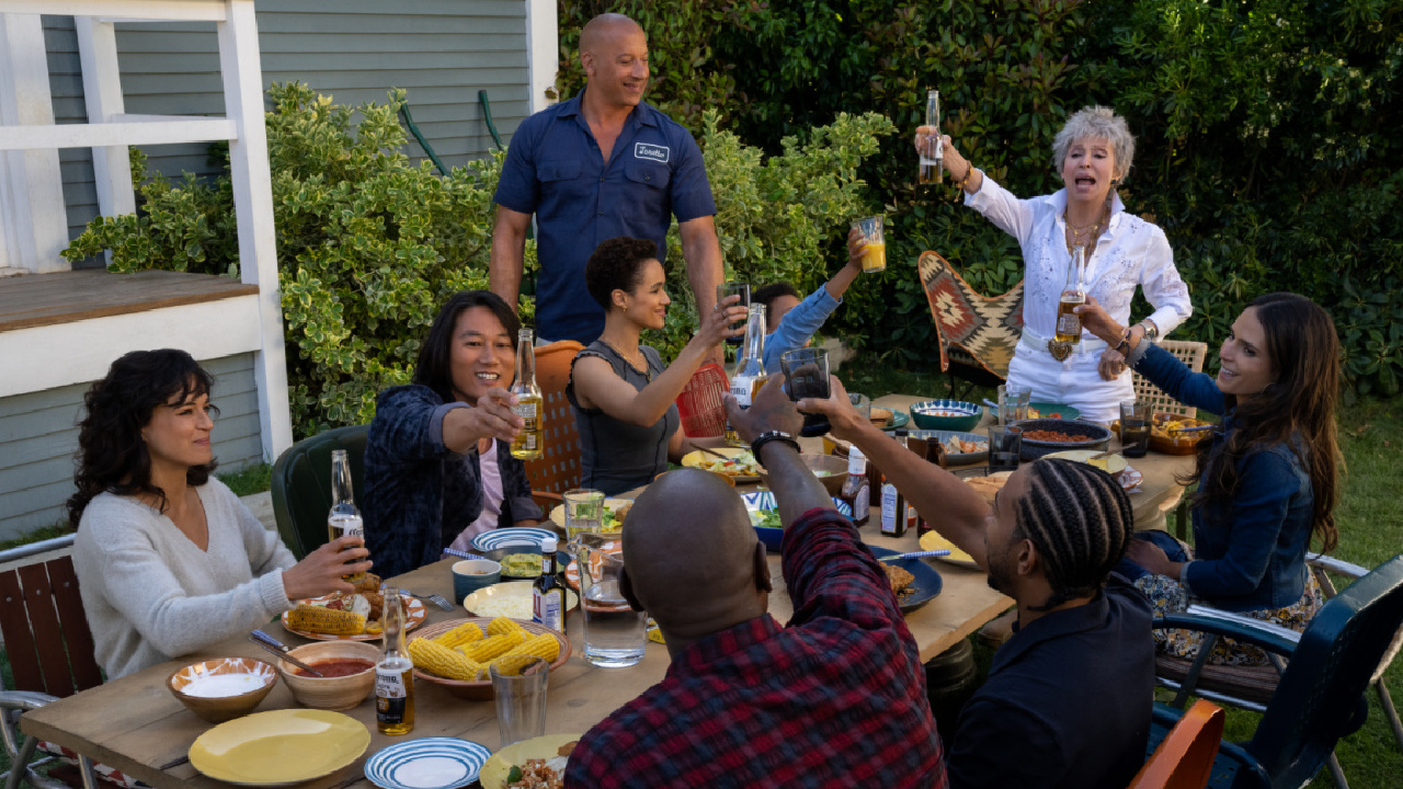 (Clockwise, from left) Letty (Michelle Rodriguez), Han (Sung Kang), Ramsey (Nathalie Emmanuel), Dom (Vin Diesel), Little Brian (Leo Abelo Perry), Abuelita (Rita Moreno), Mia (Jordana Brewster), Tej (Chris ‘Ludacris’ Bridges, back to camera) and Roman (Tyrese Gibson, back to camera) in 'Fast X,' directed by Louis Leterrier.