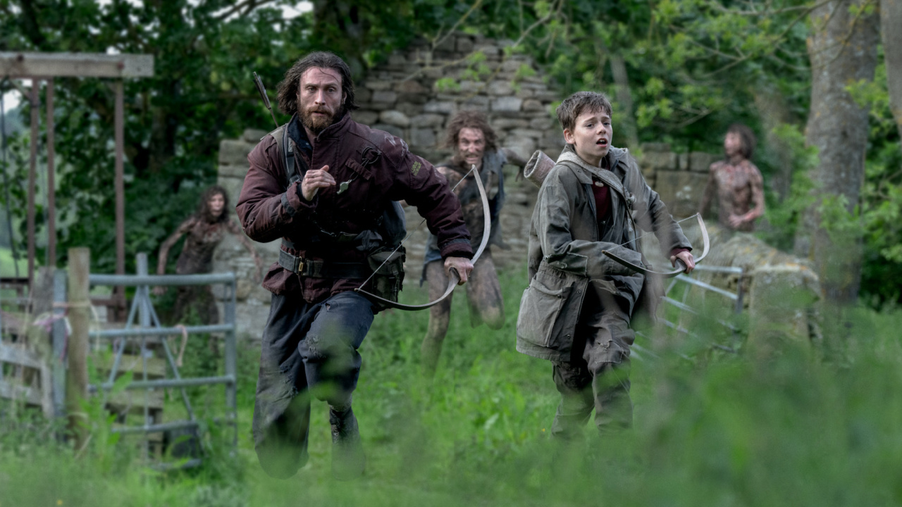 (L to R) Jamie (Aaron Taylor-Johnson) and his son Spike (Alfie Williams) in Columbia Pictures' '28 Years Later'. Photo: Miya Mizuno. © 2024 CTMG, Inc. All Rights Reserved.