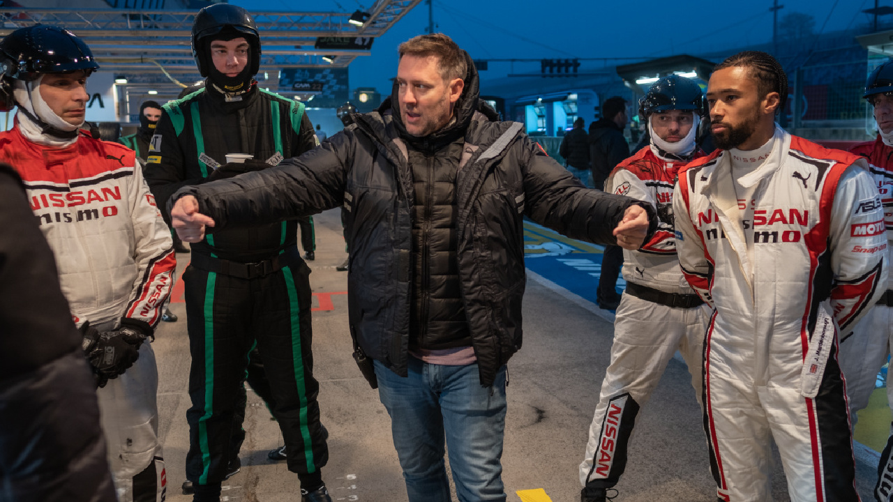 Director Neill Blomkamp (center) and the real Jann Mardenborough (right) with additional crew on the set of Columbia Pictures 'Gran Turismo. Photo: Gordon Timpen.