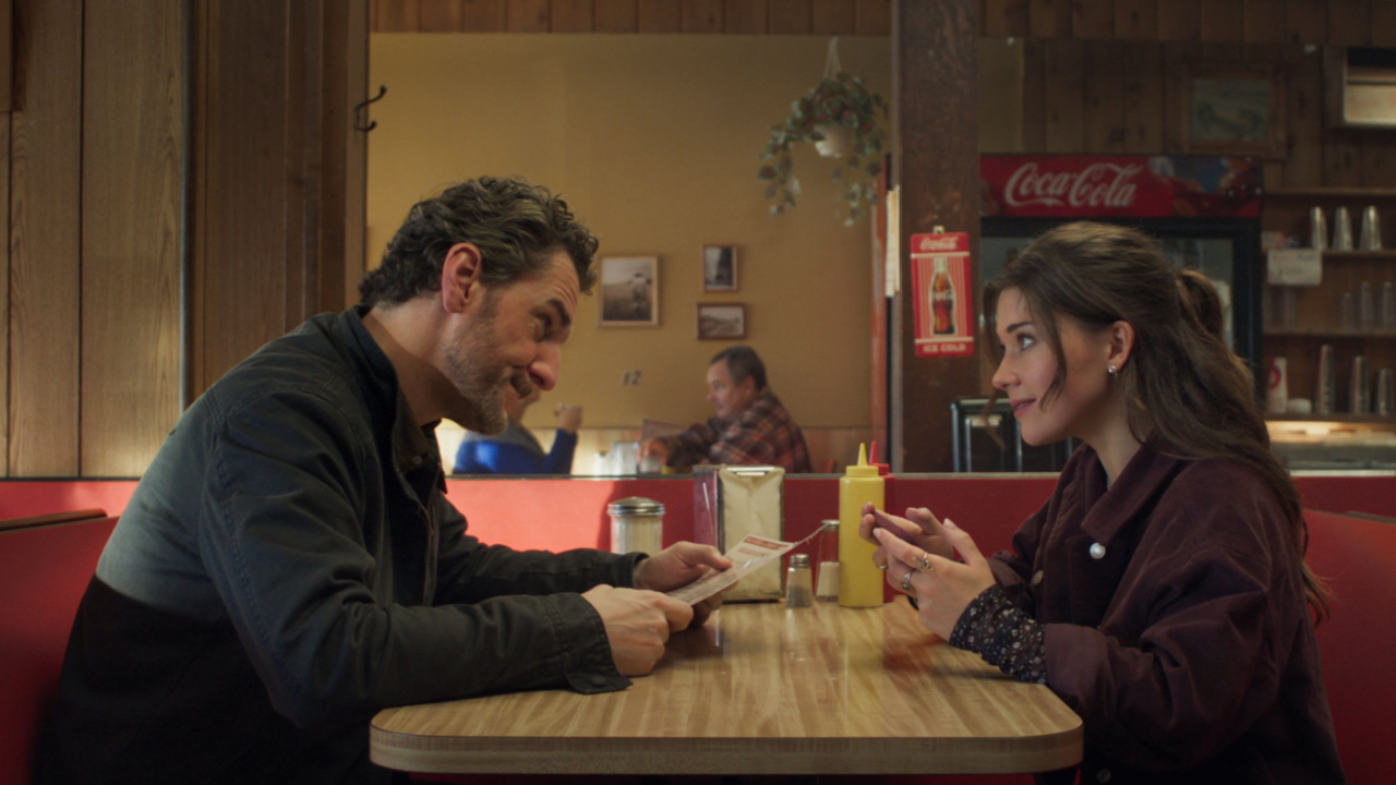 (L to R) Aaron Abrams and Katie Douglas in Eli Craig’s 'Clown in a Cornfield.' Courtesy of RLJE Films & Shudder. An RLJE Films & Shudder Release.