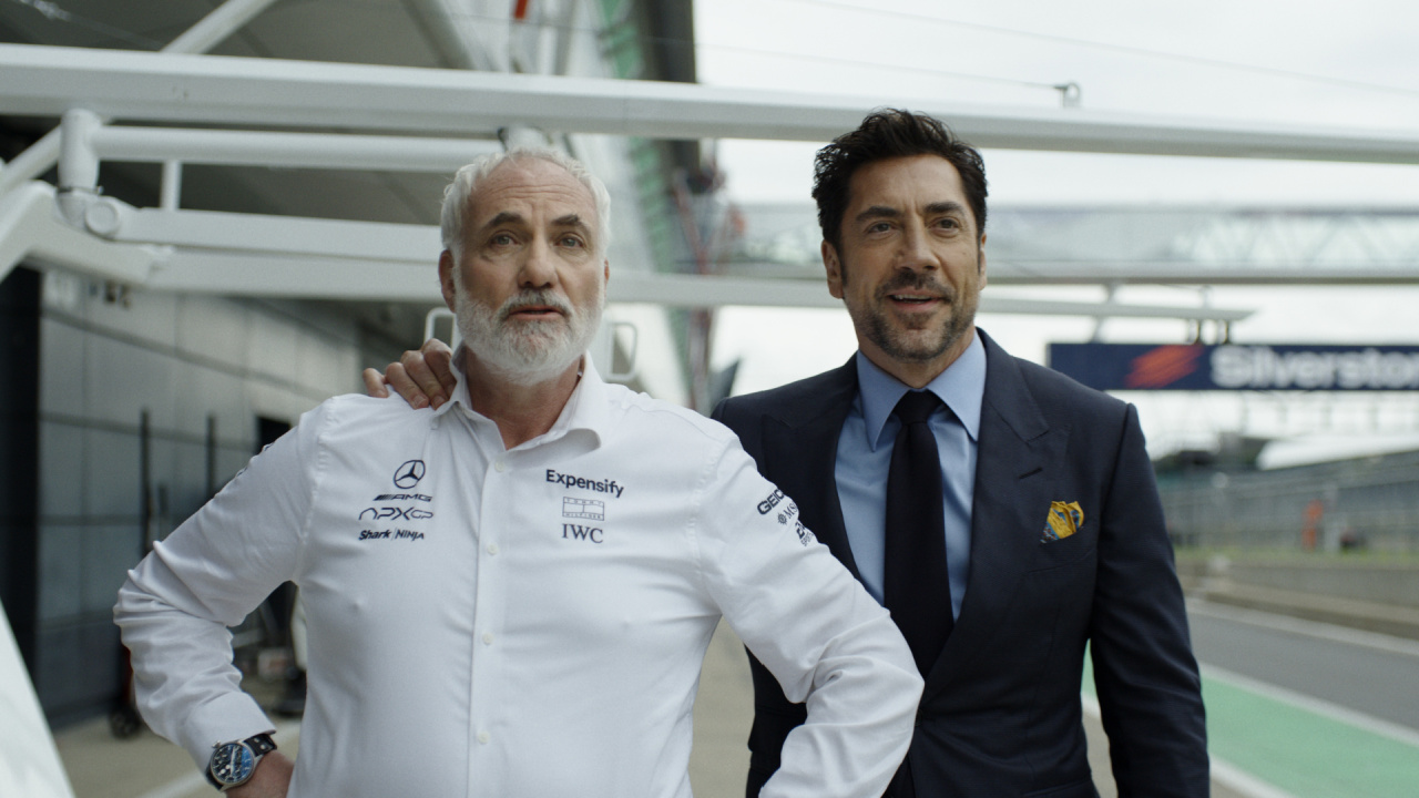 (L to R) Kim Boonia as Kaspar and Javier Bardem as Ruben Cervantes in Apple Original Films’ 'F1' a Warner Bros. Pictures release. Photo Credit: Photo Courtesy Warner Bros. Pictures / Apple Original Films. Copyright: © 2025 Warner Bros. Entertainment Inc. All Rights Reserved.