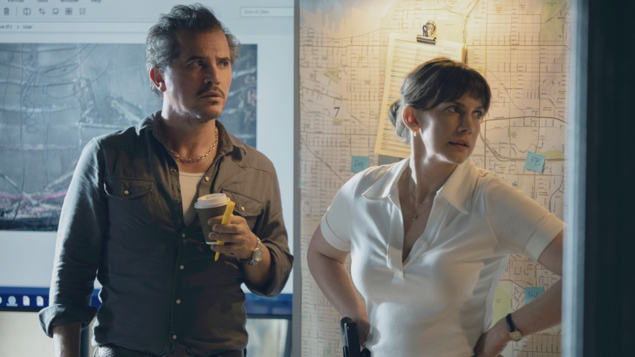 (L to R) John Leguizamo and Anna Chlumsky in 'Smoke,' premiering June 27, 2025 on Apple TV+.