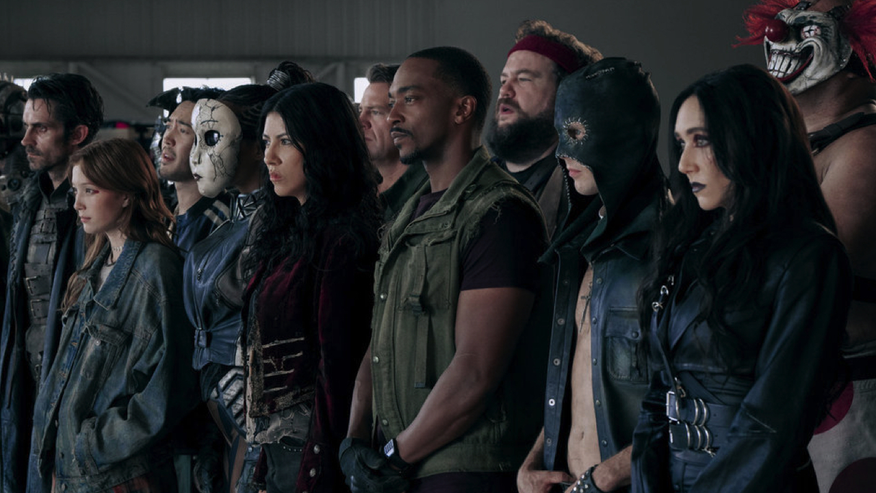 (L tor R) Richard De Klerk as Mr. Grimm, Saylor Bell Curda as Mayhem, Andre De Kim as Chuckie Floop, Tiana Okoye as Dollface, Stephanie Beatriz as Quiet, Johnno Wilson as Dave, Anthony Mackie as John Doe, Mike Mitchell as Stu, Tyler Johnston as Deacon, Patty Guggenheim as Raven, Joe Seanoa as Sweet Tooth in 'Twisted Metal' Season 2. Photo: Pief Weyman/PEACOCK.