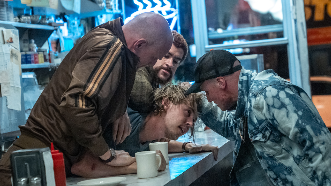 (L to R) Pavel (Nikita Kukushkin), Colorado (Bad Bunny), and Aleksei (Yuri Kolokolnikov) rough up Hank (Austin Butler) in Columbia Pictures 'Caught Stealing'. Photo: Niko Tavernise. © 2024 CTMG, Inc. All Rights Reserved. **ALL IMAGES ARE PROPERTY OF SONY PICTURES ENTERTAINMENT INC. FOR PROMOTIONAL USE ONLY. SALE, DUPLICATION OR TRANSFER OF THIS MATERIAL IS STRICTLY PROHIBITED.