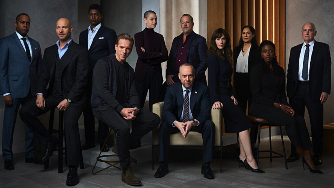 (L to R) Daniel Breaker as Roger “Scooter” Dunbar, Corey Stoll as Mike Prince, Toney Goins as Philip Charyn, Damian Lewis as Bobby "Axe" Axelrod, Asia Kate Dillon as Taylor Mason, David Costabile as Mike ‘Wags’ Wagner, Paul Giamatti as Chuck Rhoades, Maggie Siff as Wendy Rhoades, Sakina Jaffrey as Daevisha ‘Dave’ Mahar, Dola Rashad as Kate Sacker and Jeffrey DeMunn as Chuck Rhoades, Sr. in 'Billions' Season 7. Photo Credit: Mark Seliger/Showtime