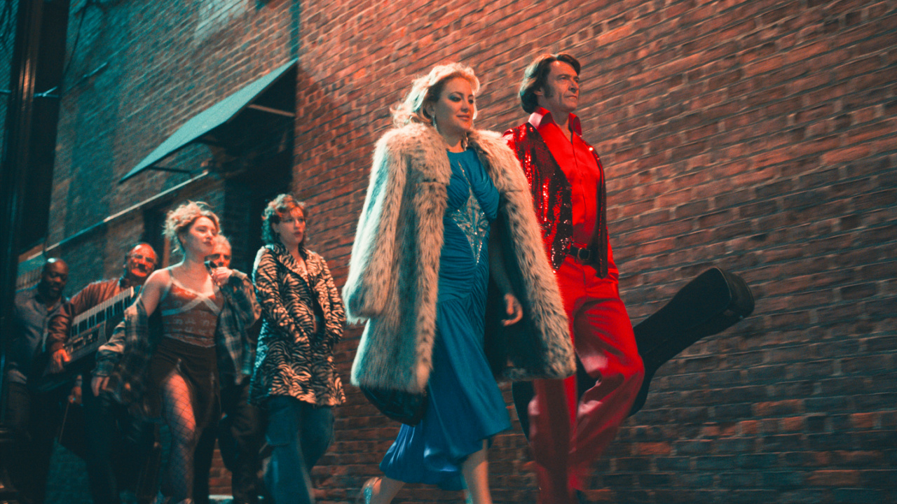 (L to R) Jim Belushi as Tom D'Amato, Ella Anderson as Rachel, Michael Imperioli as Mark Shurilla, King Princess as Angelina, Kate Hudson as Claire Stengl, and Hugh Jackman as Mike Sardina in director Craig Brewer's 'Song Sung Blue', a Focus Features release. Credit: Courtesy of Focus Features © 2025 All Rights Reserved.