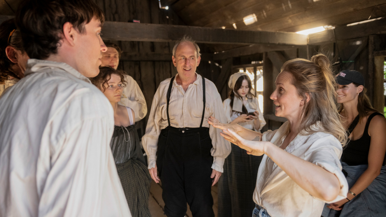 Mona Fastvold with cast and crew on the set of 'The Testament of Ann Lee'. Photo courtesy of Searchlight Pictures. © 2025 Searchlight Pictures All Rights Reserved.