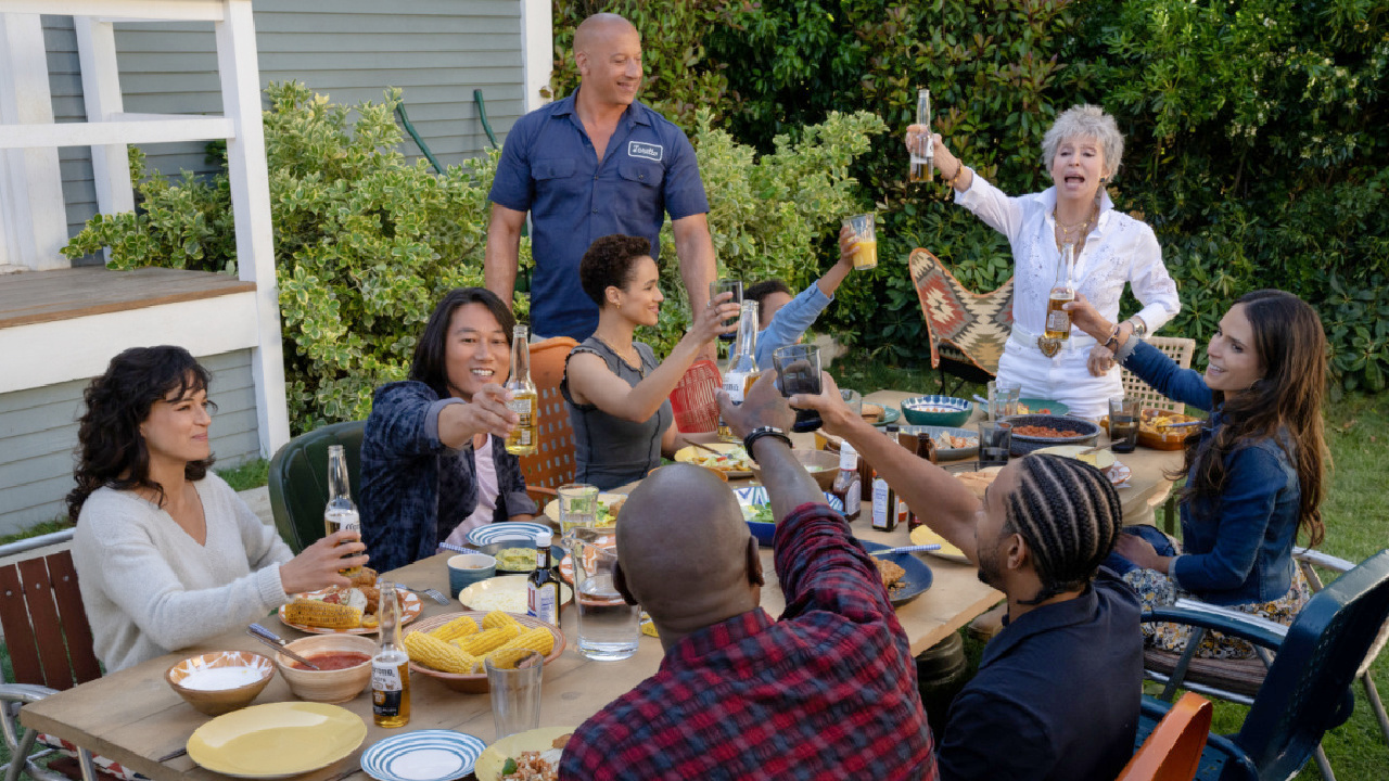 (Clockwise, from left) Letty (Michelle Rodriguez), Han (Sung Kang), Ramsey (Nathalie Emmanuel), Dom (Vin Diesel), Little Brian (Leo Abelo Perry), Abuelita (Rita Moreno), Mia (Jordana Brewster), Tej (Chris ‘Ludacris’ Bridges, back to camera) and Roman (Tyrese Gibson, back to camera) in 'Fast X,' directed by Louis Leterrier.